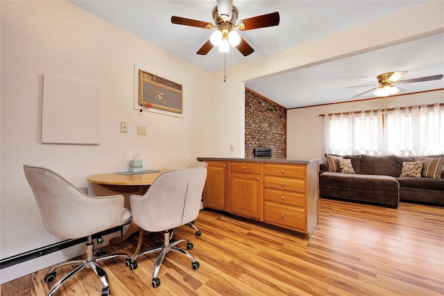 dining area featuring a wall mounted air conditioner, light wood-style floors, and ceiling fan