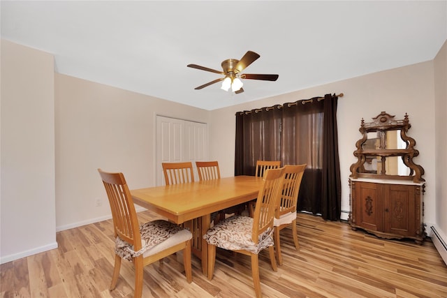 dining space featuring baseboards, light wood-type flooring, baseboard heating, and ceiling fan