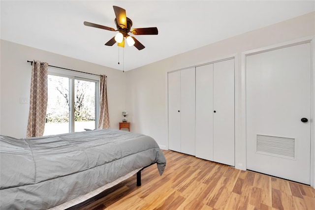 bedroom with a closet, visible vents, light wood-type flooring, and a ceiling fan