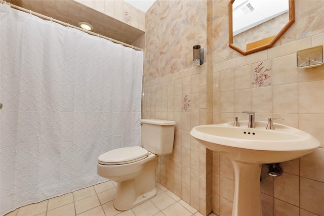 full bathroom with tile patterned flooring, visible vents, toilet, a shower with curtain, and tile walls