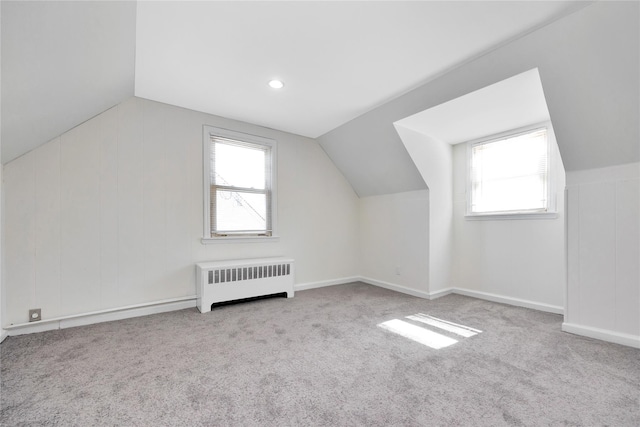 bonus room with vaulted ceiling, radiator heating unit, plenty of natural light, and carpet floors