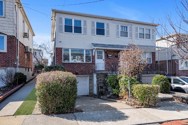 view of front of property featuring brick siding, concrete driveway, and an attached garage