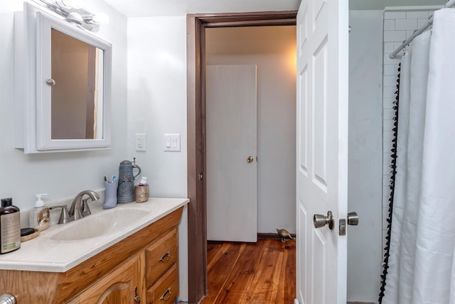 bathroom with wood finished floors and vanity