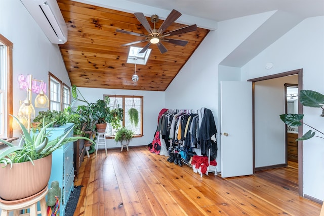 interior space featuring an AC wall unit and lofted ceiling with skylight