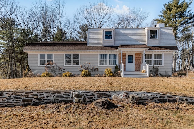 view of front of home featuring a shingled roof