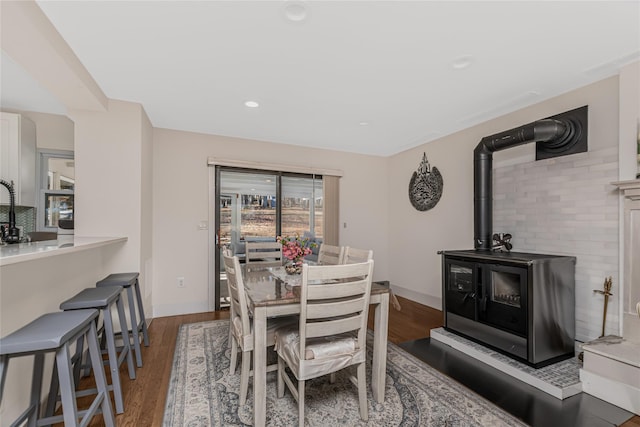 38 Marjorie Dr, Monticello, NY 12701 - dining room featuring recessed lighting, a wood stove, baseboards, and wood finished floors