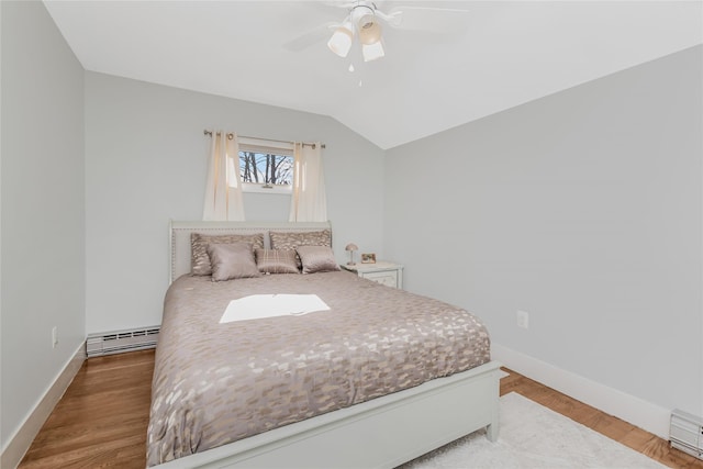 38 Marjorie Dr, Monticello, NY 12701 - bedroom featuring light wood-type flooring, a baseboard heating unit, baseboards, baseboard heating, and vaulted ceiling