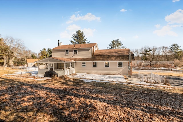 38 Marjorie Dr, Monticello, NY 12701 - back of property with a chimney, fence, a patio, and a sunroom