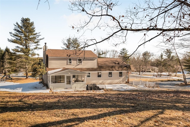 38 Marjorie Dr, Monticello, NY 12701 - back of house with a patio, a chimney, and a sunroom