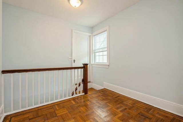 unfurnished room featuring baseboards