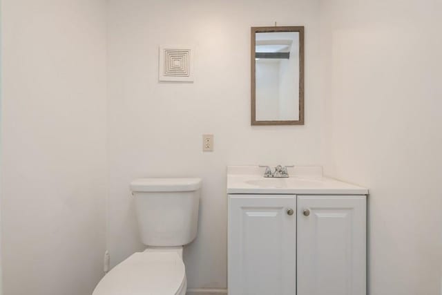 half bath featuring toilet and vanity