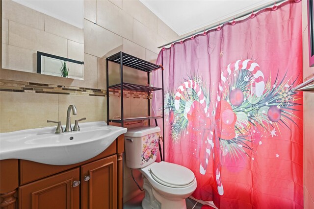 bathroom featuring vanity, tile walls, toilet, and backsplash