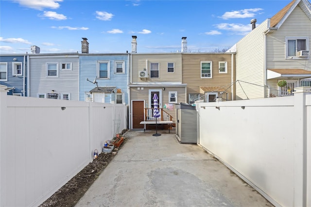 back of property with a fenced backyard