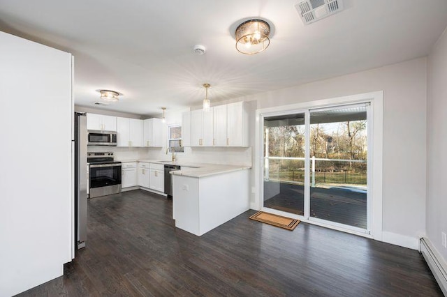 kitchen featuring visible vents, dark wood-style floors, appliances with stainless steel finishes, light countertops, and a baseboard radiator