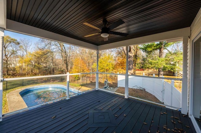 deck with a jacuzzi, fence, and ceiling fan