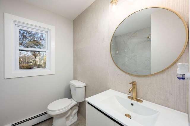 bathroom with a baseboard heating unit, tile walls, toilet, and vanity