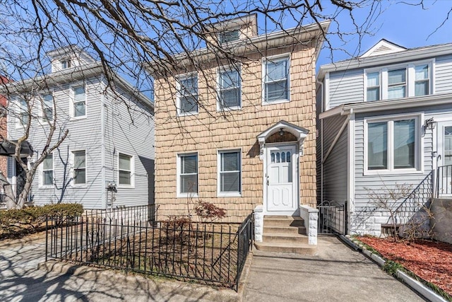 traditional style home featuring entry steps and fence