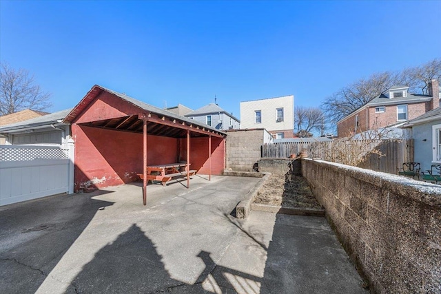 exterior space with an outbuilding, an attached garage, and an exterior structure