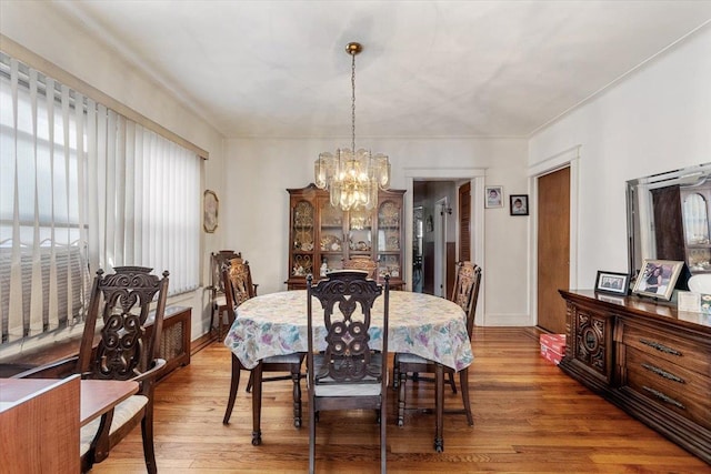 dining area featuring a notable chandelier and wood finished floors