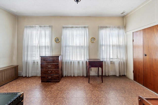 unfurnished bedroom with radiator and light floors