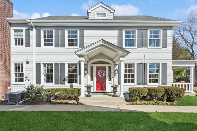 view of front of house featuring a shingled roof and central AC