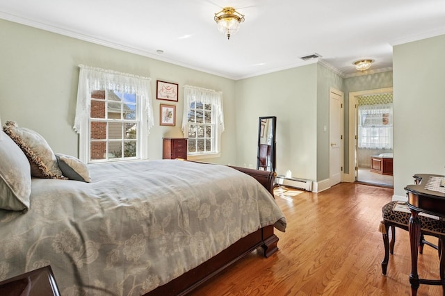 bedroom with visible vents, crown molding, a baseboard heating unit, baseboards, and wood finished floors