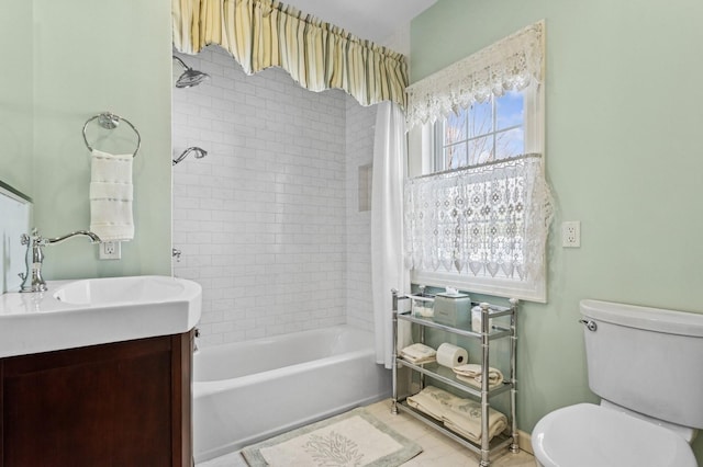 bathroom with vanity, toilet, shower / bathing tub combination, and baseboards