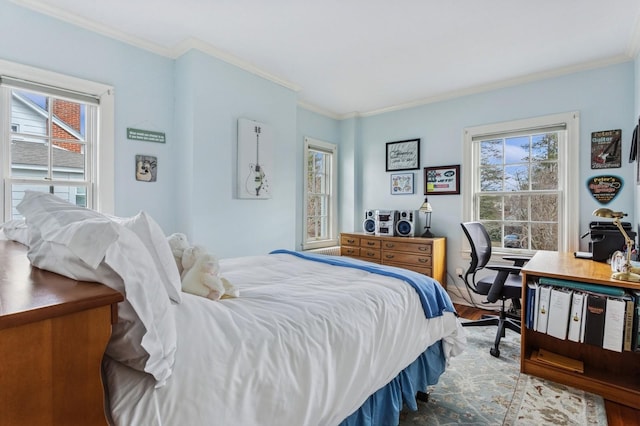 bedroom featuring multiple windows, crown molding, and wood finished floors