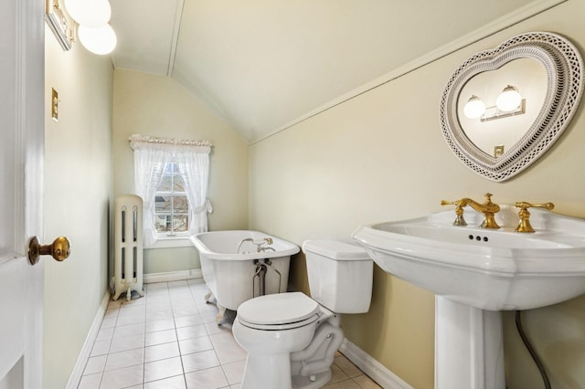 bathroom featuring radiator, a freestanding bath, tile patterned flooring, vaulted ceiling, and toilet