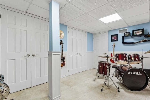 playroom featuring tile patterned floors, visible vents, a drop ceiling, and wainscoting