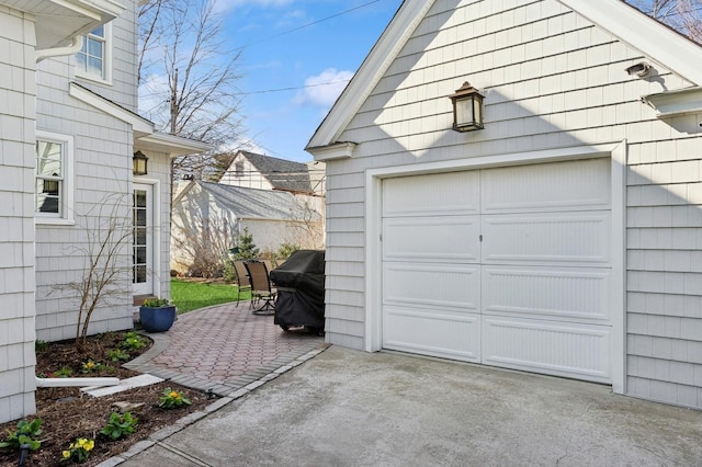 garage with concrete driveway