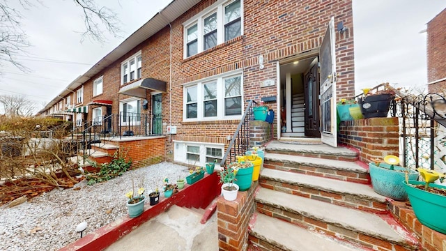 doorway to property with brick siding