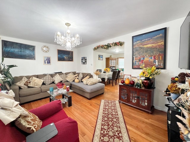 living area with a chandelier and wood finished floors