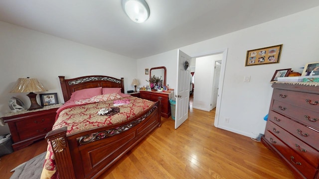 bedroom with light wood-style flooring and baseboards