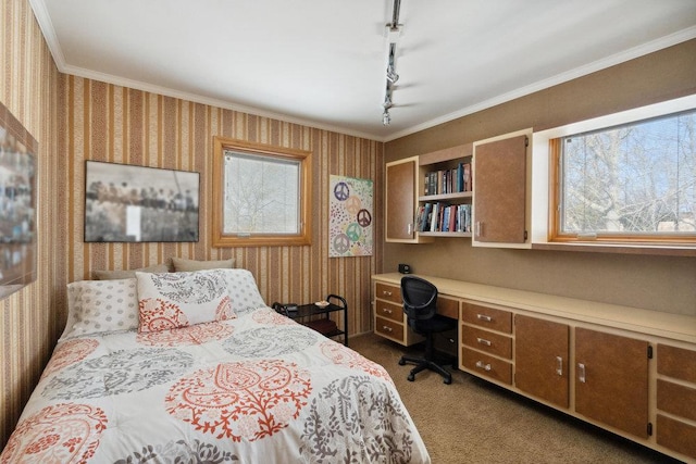 bedroom with wallpapered walls, crown molding, built in desk, and dark carpet