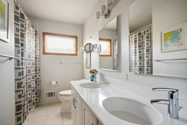 bathroom featuring tile patterned flooring, toilet, visible vents, and a sink