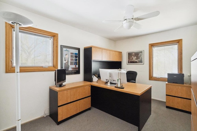 carpeted office with baseboards and ceiling fan