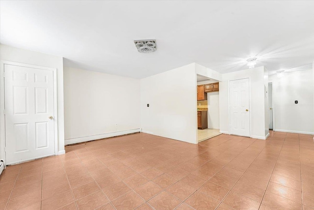 empty room with visible vents, baseboards, and a baseboard radiator