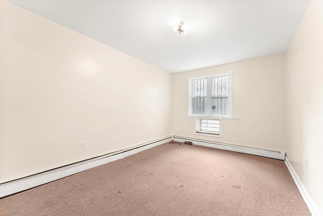 carpeted empty room featuring baseboards