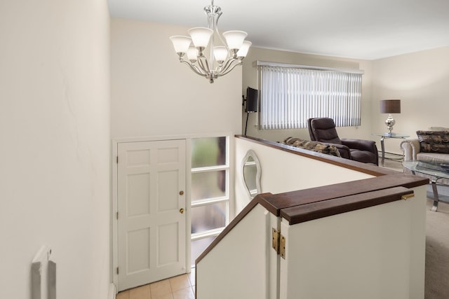 foyer featuring a chandelier and light tile patterned flooring