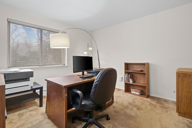 office with light carpet, baseboard heating, and baseboards