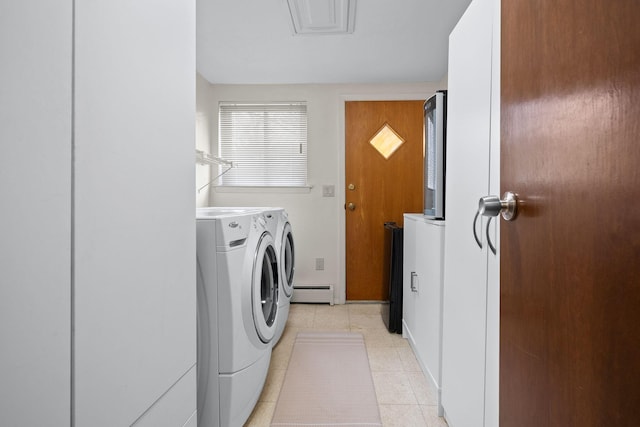 washroom featuring washer and dryer, laundry area, light tile patterned flooring, and a baseboard radiator