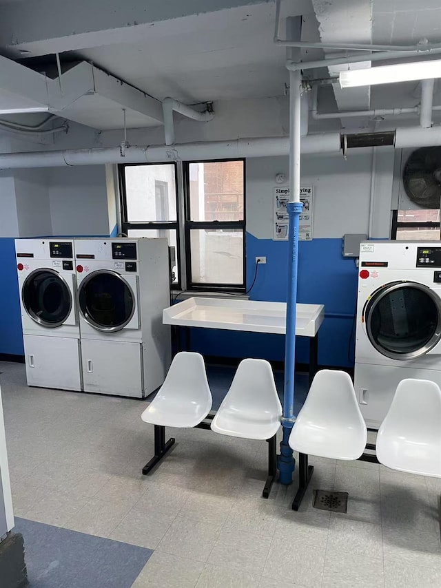 shared laundry area featuring tile patterned floors and washer and dryer