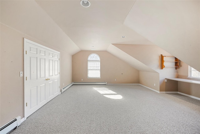 bonus room with baseboard heating, carpet flooring, baseboards, and lofted ceiling