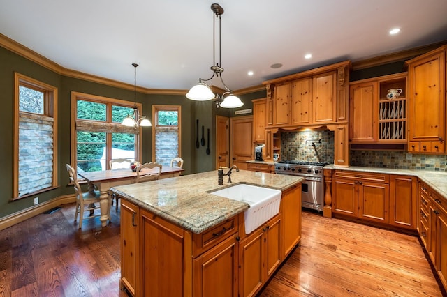 83 Ithaca Ave, Atlantic Beach, NY 11509 - kitchen featuring a sink, backsplash, high end stainless steel range oven, and brown cabinets