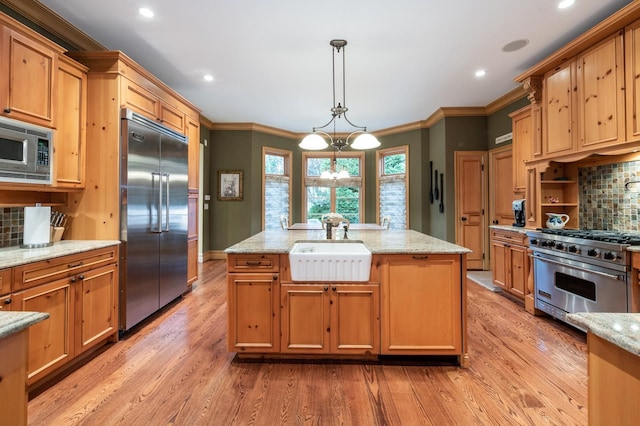 83 Ithaca Ave, Atlantic Beach, NY 11509 - kitchen featuring built in appliances, decorative backsplash, a sink, and light wood-type flooring