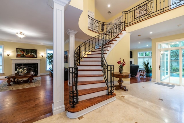 83 Ithaca Ave, Atlantic Beach, NY 11509 - stairway with a premium fireplace, ornamental molding, ornate columns, and tile patterned flooring