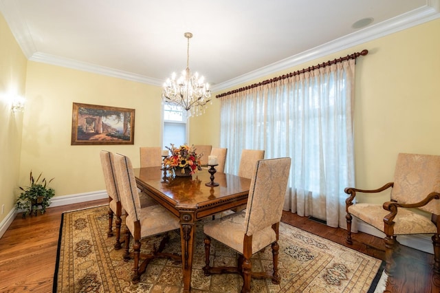 83 Ithaca Ave, Atlantic Beach, NY 11509 - dining room with crown molding, baseboards, wood finished floors, and a chandelier