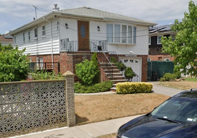 view of front of property with stairs, a garage, and brick siding