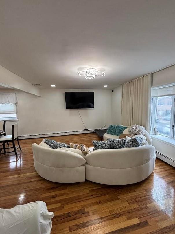 162-30 89th St, Howard Beach, NY 11414 - living room with baseboard heating, wood finished floors, and recessed lighting